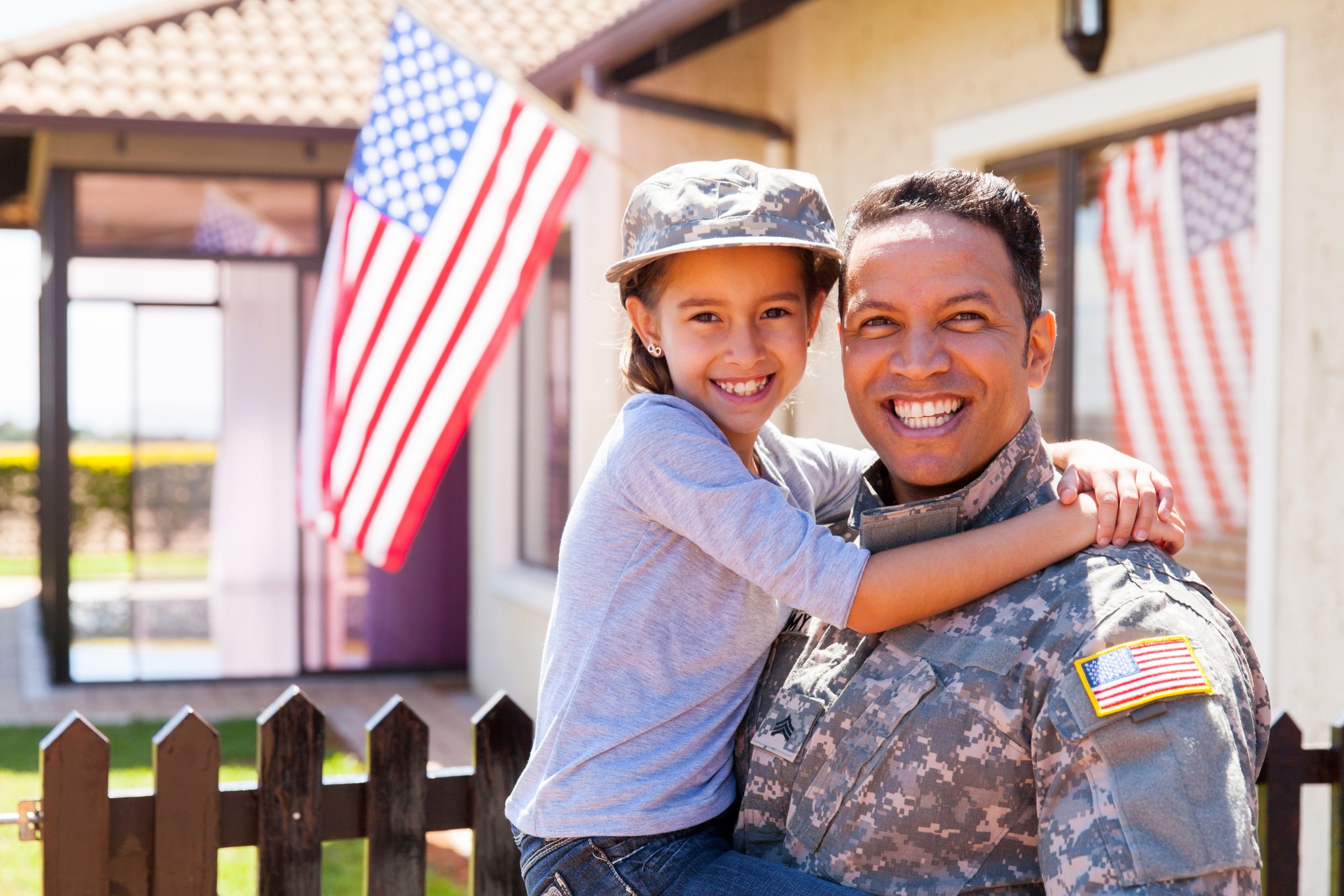 US Army soldier and little daughter outside their home.